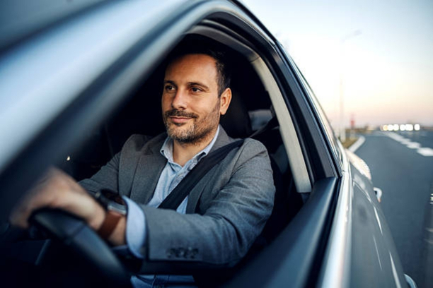 Experienced chauffeur driving an airport taxi service vehicle
